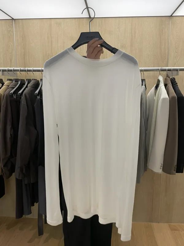 シンプルなホワイト長袖Tシャツ、快適で通気性が良く、ファッショナブルで多用途