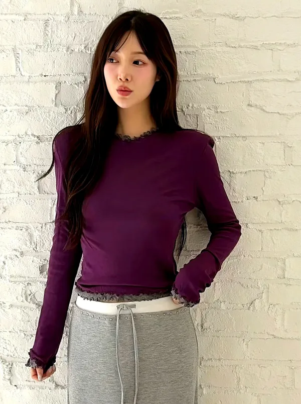 Elegant purple long-sleeve women's top with lace trim design.
