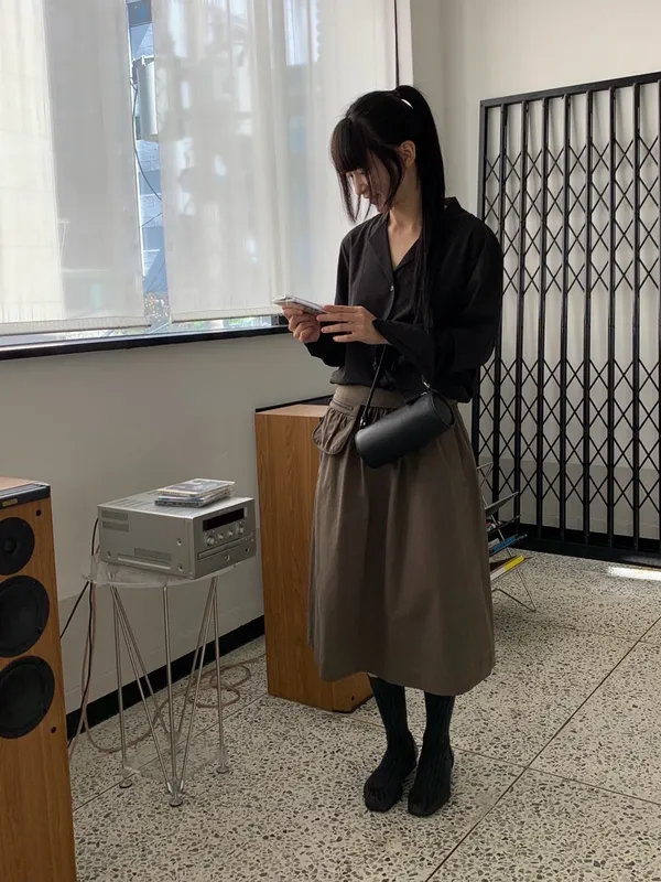 Minimalist Black Jacket Paired with Casual Skirt